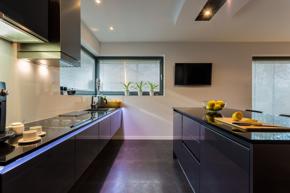 View of dark furniture in white painted kitchen